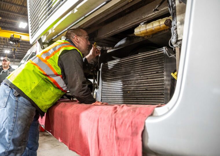 Man inspecting vehicle radiator